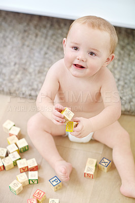 Buy stock photo Shot of an adorable little boy wearing his diaper while playing with his blocks