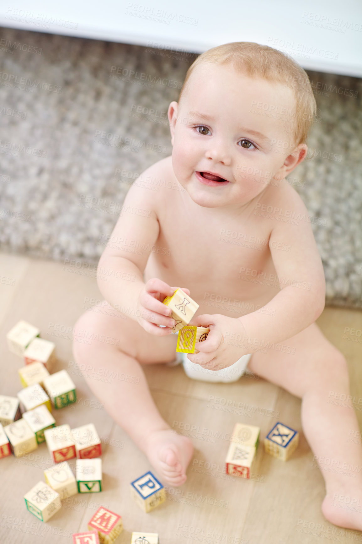 Buy stock photo Shot of an adorable little boy wearing his diaper while playing with his blocks