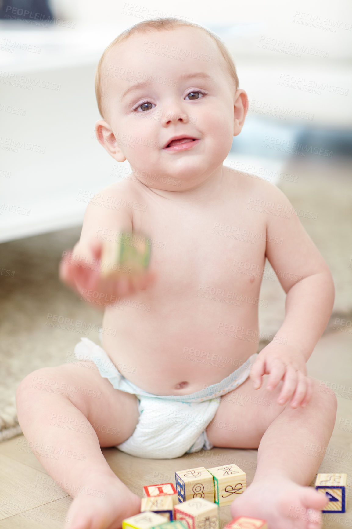 Buy stock photo Shot of an adorable little boy wearing his diaper while playing with his blocks