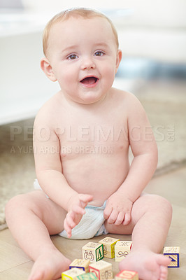 Buy stock photo Shot of an adorable little boy wearing his diaper while playing with his blocks