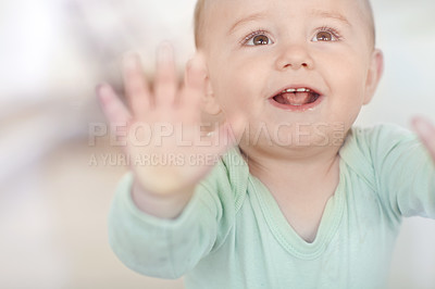 Buy stock photo An adorable little boy pressing against a glass window