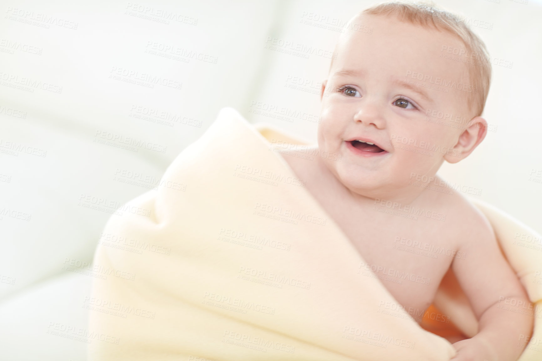 Buy stock photo Shot of a cute little baby boy wrapped in his blanket