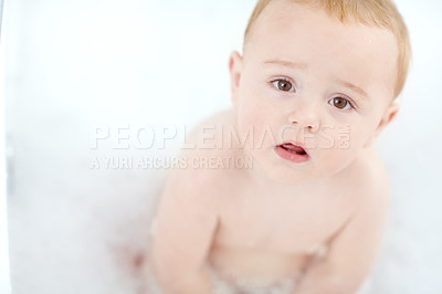 Buy stock photo Portrait of an adorable baby boy sitting in a bathtub