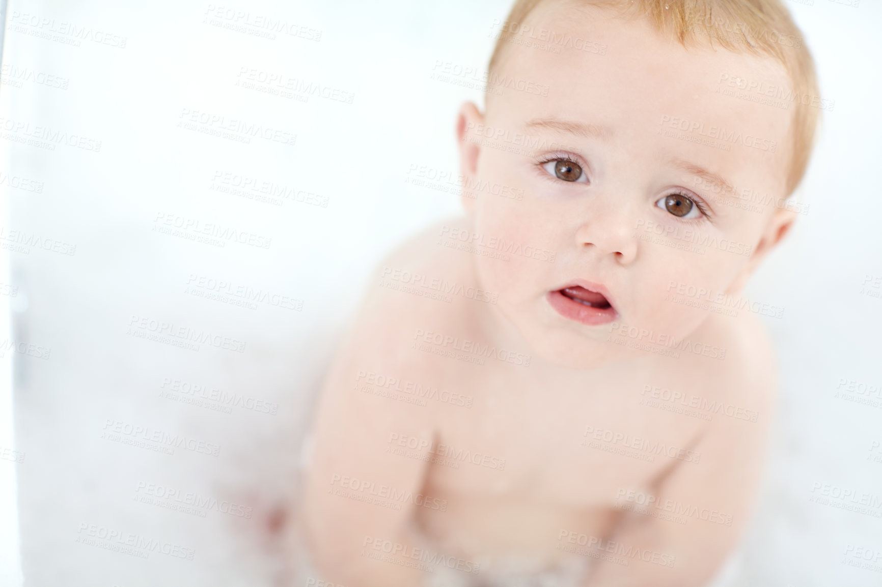 Buy stock photo Portrait of an adorable baby boy sitting in a bathtub