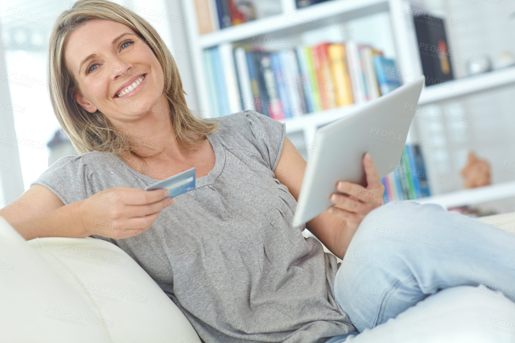 Buy stock photo Portrait of an attractive mature woman doing some online shopping at home