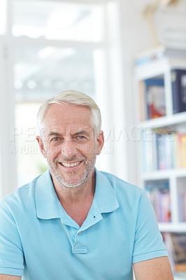 Buy stock photo Cropped portrait of a handsome mature man relaxing at home