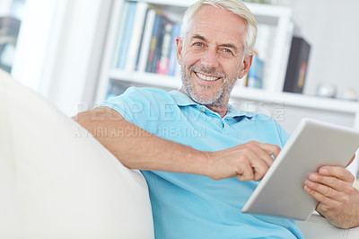 Buy stock photo Portrait of a handsome mature man using his digital tablet at home