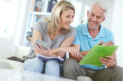 Buy stock photo Senior couple, home budget and finance with a calculator and bills for investment, savings or debt. Man and woman in happy marriage with paperwork for retirement, mortgage or to invest pension