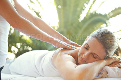 Buy stock photo Shot of an attractive mature woman enjoying a massage at a day spa