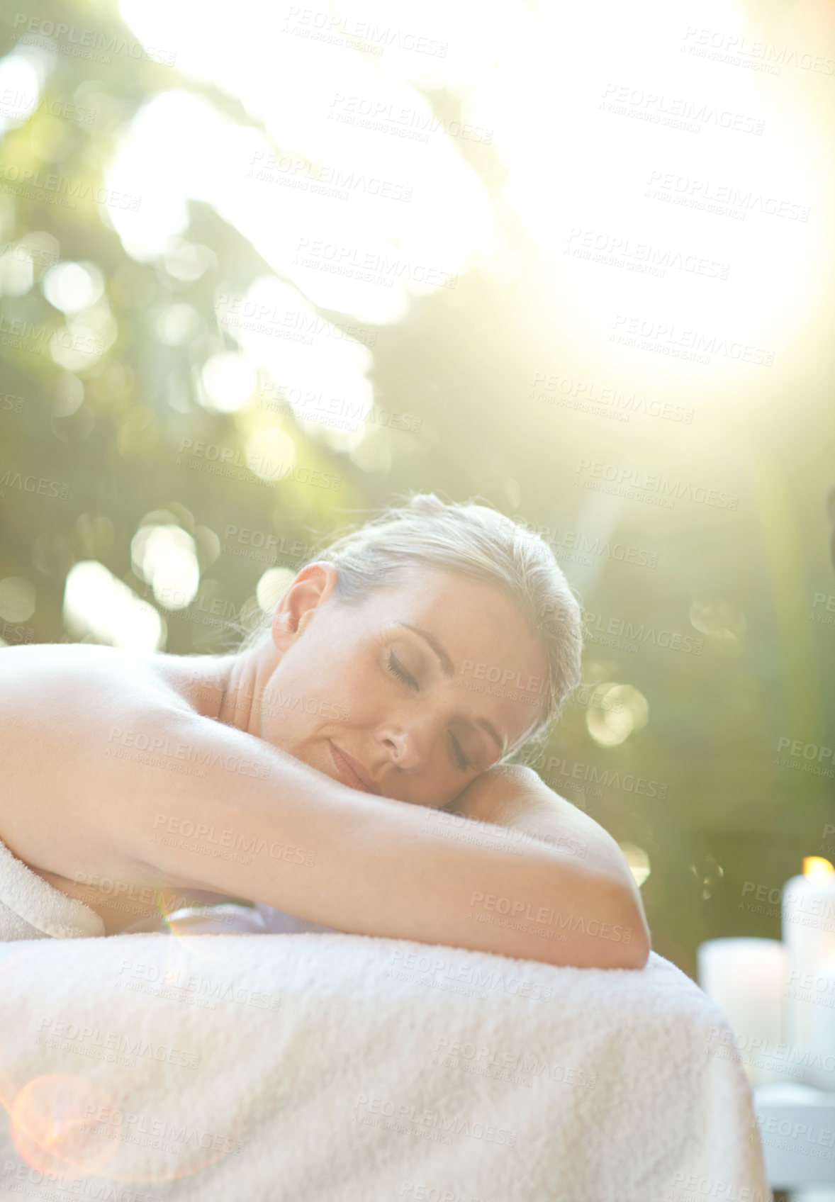 Buy stock photo Shot of an attractive mature woman relaxing on a massage table at a spa