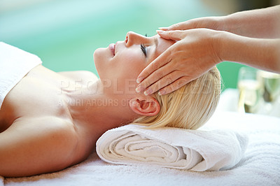 Buy stock photo Shot of a beautiful woman enjoying a head massage at a spa