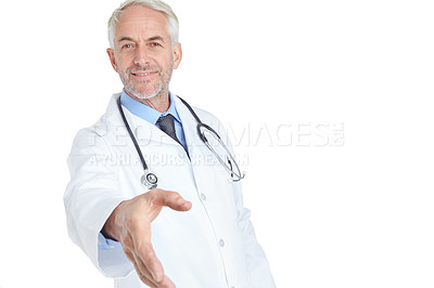 Buy stock photo Shot of a handsome mature male doctor extending his hand in greeting towards the camera