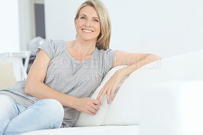 Buy stock photo Portrait of an attractive mature woman relaxing on the sofa at home