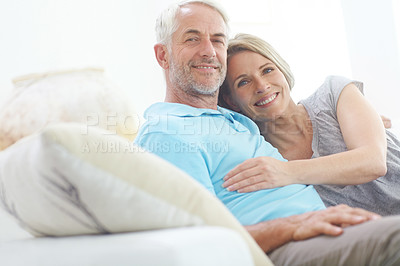Buy stock photo Portrait of a happy mature couple relaxing on the sofa at home
