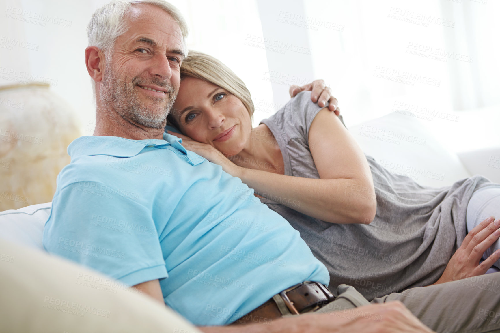 Buy stock photo Portrait of a loving mature couple relaxing on the sofa at home