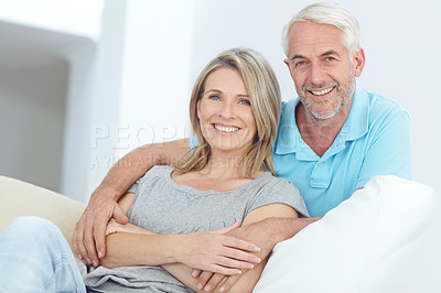 Buy stock photo Portrait of a happy mature couple relaxing at home