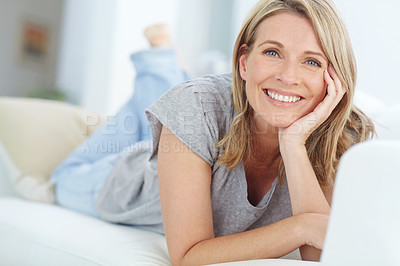 Buy stock photo Portrait of mature woman lying on sofa in living room, happiness and relaxing in comfort at home. Smile, lazy weekend time and happy woman in peace chilling on comfortable couch in apartment on break