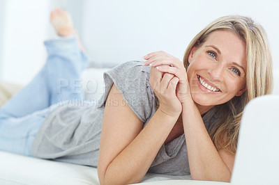 Buy stock photo Relax, smile and portrait of woman on sofa in living room and happy relaxing in home comfort. Happiness, lazy weekend and zen, mature happy woman in peace chilling on comfortable couch in apartment.