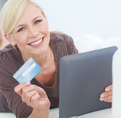 Buy stock photo Portrait of a beautiful woman doing some online shopping at home using her digital tablet