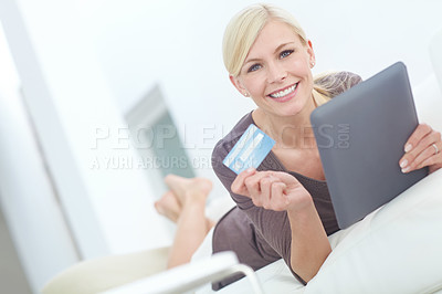 Buy stock photo Portrait of a beautiful woman doing some online shopping at home using her digital tablet