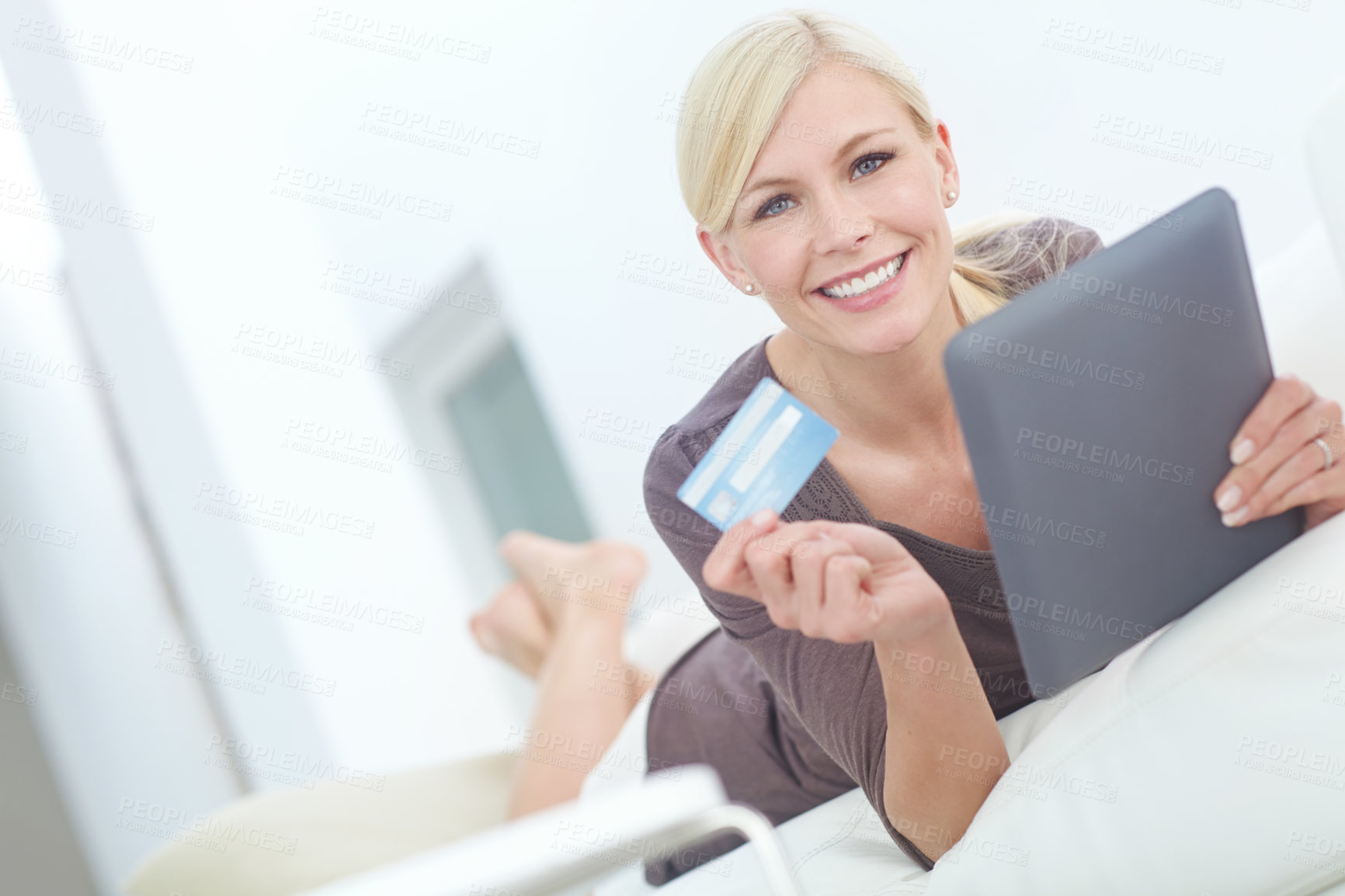 Buy stock photo Portrait of a beautiful woman doing some online shopping at home using her digital tablet