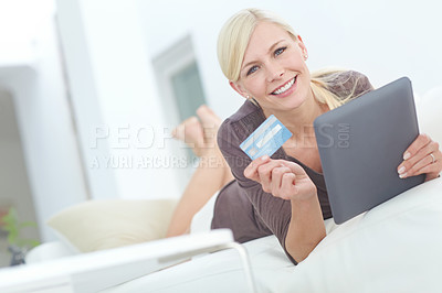 Buy stock photo Portrait of a beautiful woman doing some online shopping at home using her digital tablet