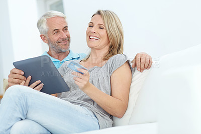 Buy stock photo Shot of a mature couple doing some online shopping at home