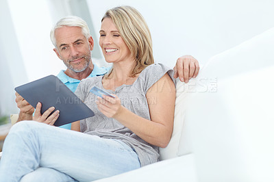 Buy stock photo Mature, happy couple or credit card on tablet banking, financial management or investment security in living room. Smile, relax man or woman on digital technology for house insurance or home loan tax