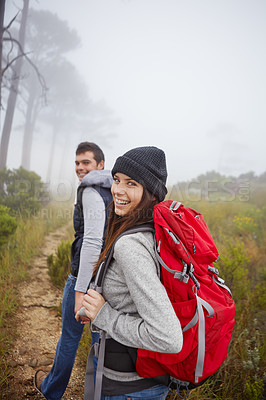 Buy stock photo Portrait of a beautiful young woman hiking along a trail with her boyfriend