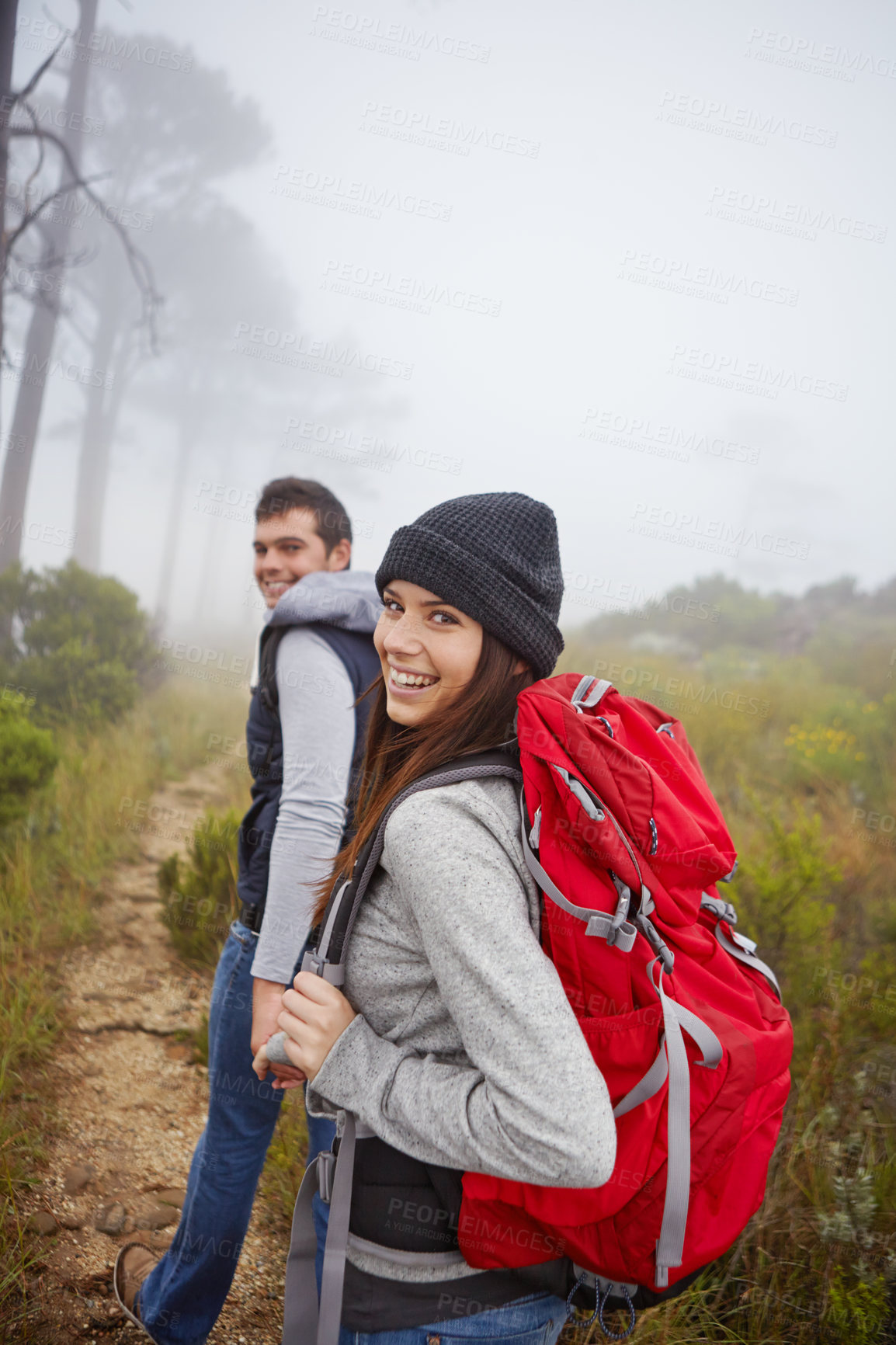 Buy stock photo Portrait of a beautiful young woman hiking along a trail with her boyfriend