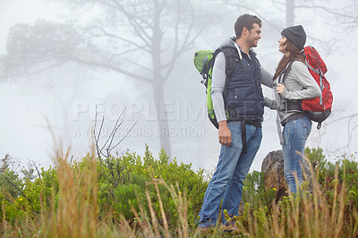 Buy stock photo Shot of a loving young couple being affectionate while on a hike