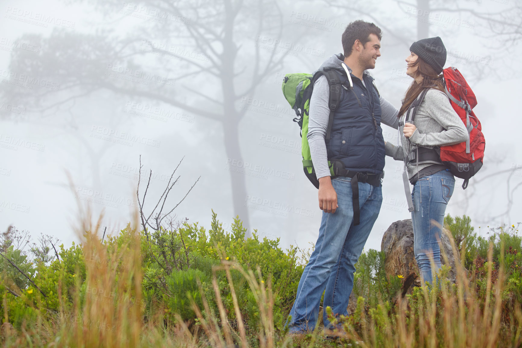 Buy stock photo Shot of a loving young couple being affectionate while on a hike