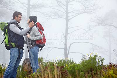 Buy stock photo Shot of a loving young couple being affectionate while out on a hike