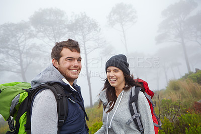 Buy stock photo Shot of a young couple enjoying a hike through nature