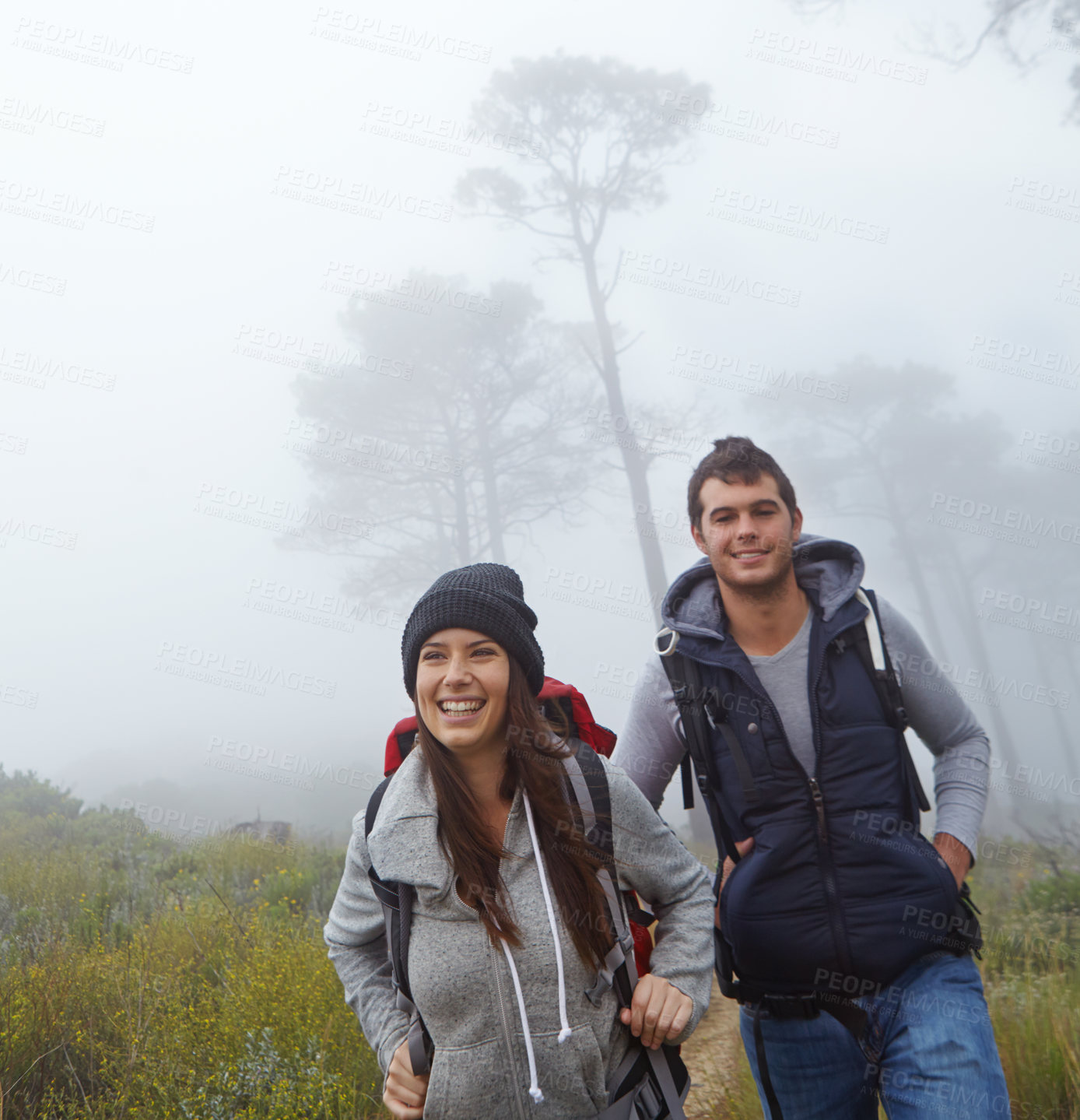 Buy stock photo Shot of a young couple enjoying a hike through nature