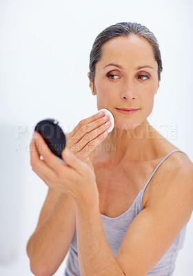 Buy stock photo Mature woman, skincare and sponge as makeup removal for beauty routine in bathroom. Female person, mirror and cotton pad for cleaning with clear skin, glow and cleanser for self care and grooming