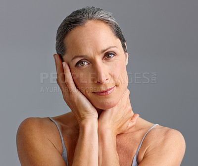 Buy stock photo Mature woman, skincare and studio portrait for beauty, confident collagen and gray background. Female person, hygiene and results of antiaging treatment, cosmetics and smooth touch for dermatology