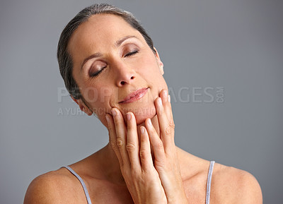 Buy stock photo Mature woman, studio and eyes closed for skincare with confidence for routine on gray background. Female person, facial and satisfied with antiaging treatment and cosmetics for beauty and self care