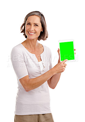 Buy stock photo Studio portrait of an attractive mature woman holding a digital tablet with a chroma key screen