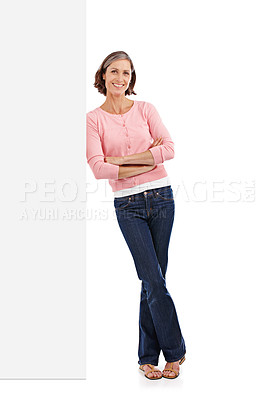 Buy stock photo Full-length studio shot of an attractive mature woman leaning against a blank white sign