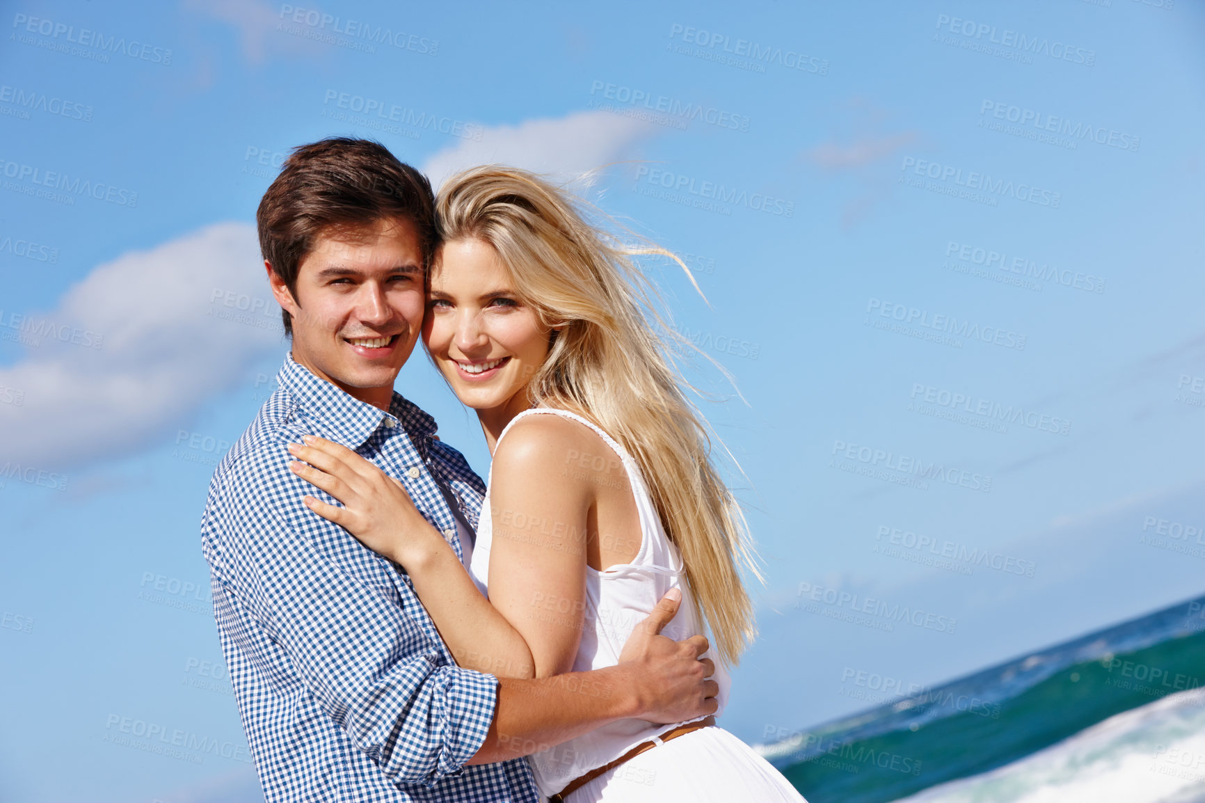 Buy stock photo Portrait of a happy young couple enjoying a romantic day on the beach