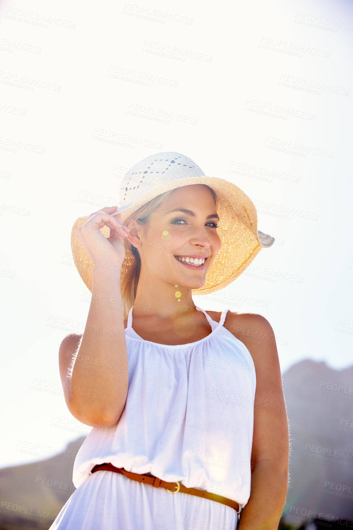 Buy stock photo Portrait of a beautiful young woman enjoying a bright summer's day outdoors