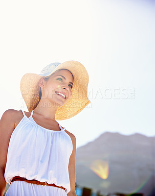 Buy stock photo Shot of a beautiful young woman enjoying a bright summer's day outdoors