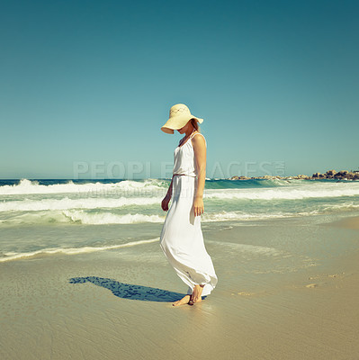Buy stock photo Shot of a beautiful young woman going for a walk on the beach