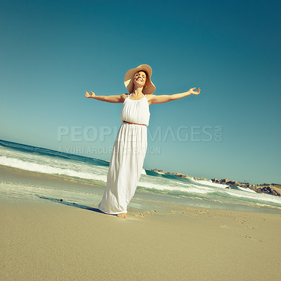 Buy stock photo Shot of a beautiful young woman enjoying a day at the beach