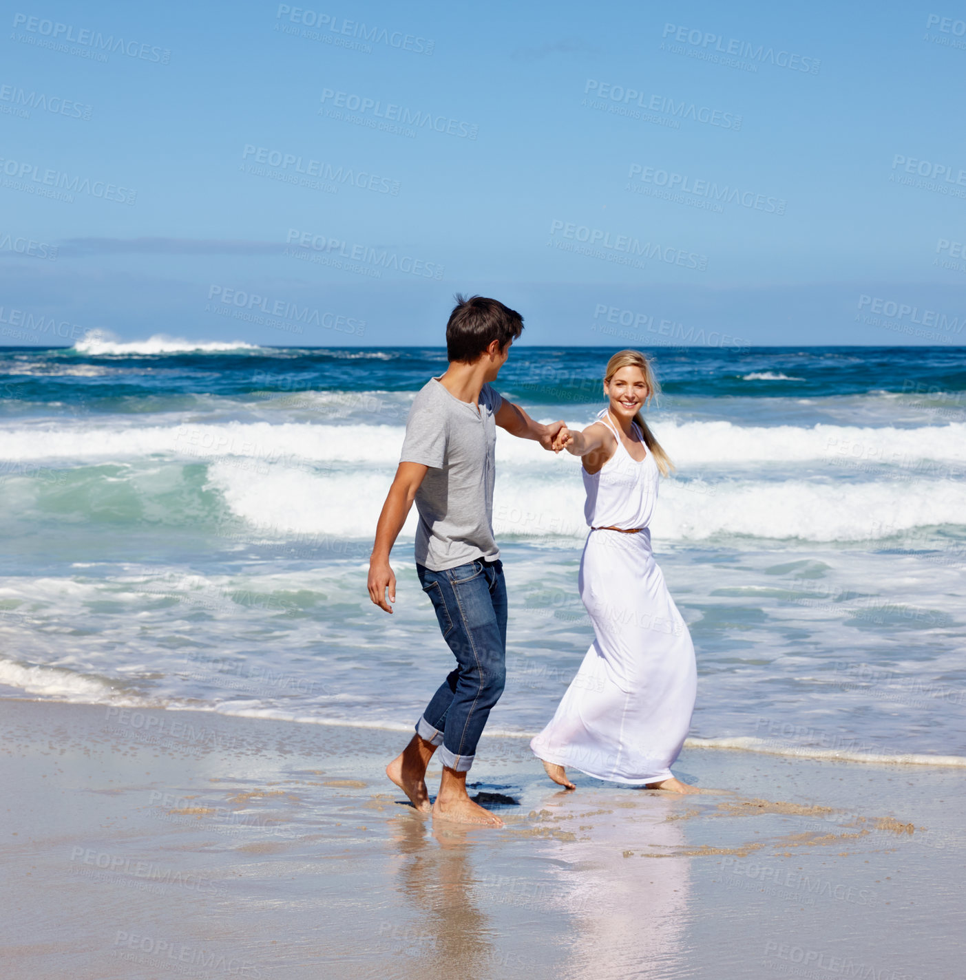 Buy stock photo Holding hands, beach and bonding of couple, water and peace for date in nature, waves and holiday. Travel, walking and smile for vacation at sea, outdoor and people in relationship, love and summer