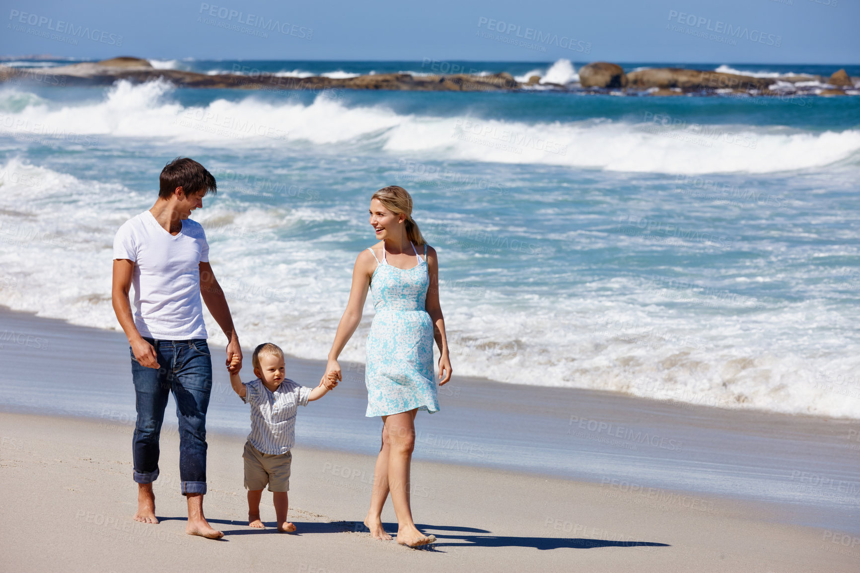 Buy stock photo Holding hands, walking or parents in ocean with baby or love on vacation, family day or holiday. Travel, toddler or mother with dad at beach for bonding together at sea on trip on island in Greece