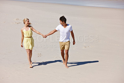 Buy stock photo Love, beach and happy couple holding hands on summer vacation, holiday and connection. Smile, man and woman on sand for support, romantic date and travel for healthy relationship outdoor with space