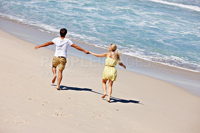 Buy stock photo Couple, freedom and holding hands at beach for travel, bonding or tropical holiday with energy. Man, woman and running outdoor for fun trip, love and vacation with adventure, relax or date on weekend