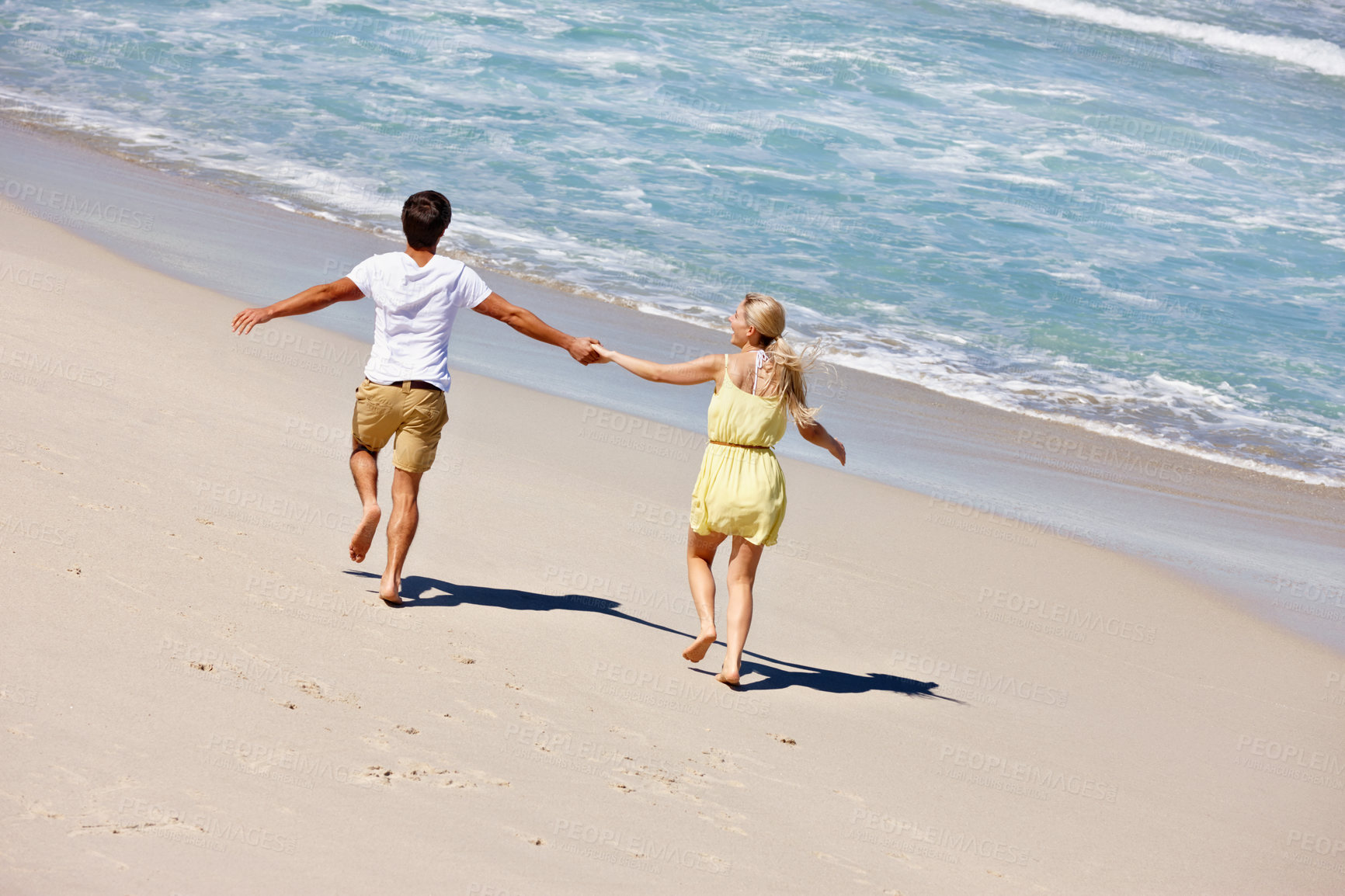 Buy stock photo Couple, freedom and holding hands at beach for travel, bonding or tropical holiday with energy. Man, woman and running outdoor for fun trip, love and vacation with adventure, relax or date on weekend